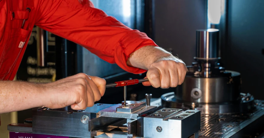 a man who is working on a machine