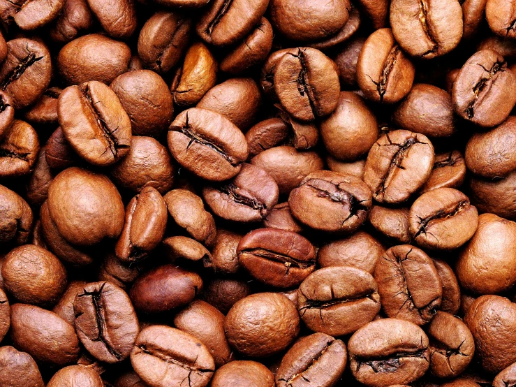 a pile of coffee beans with a pattern