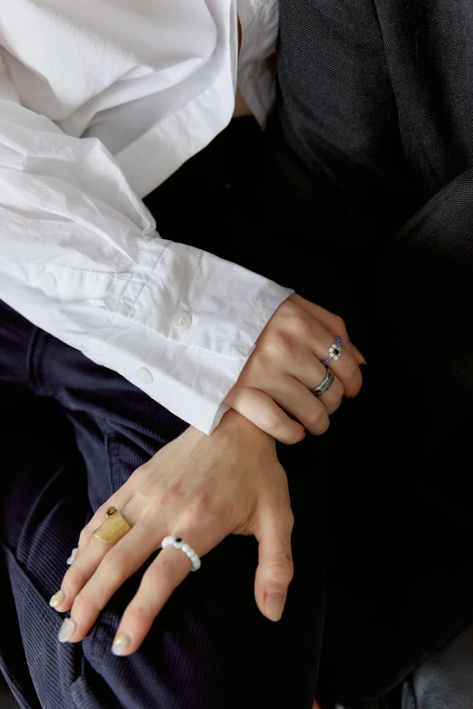 woman's hands wearing wedding rings and jewelry