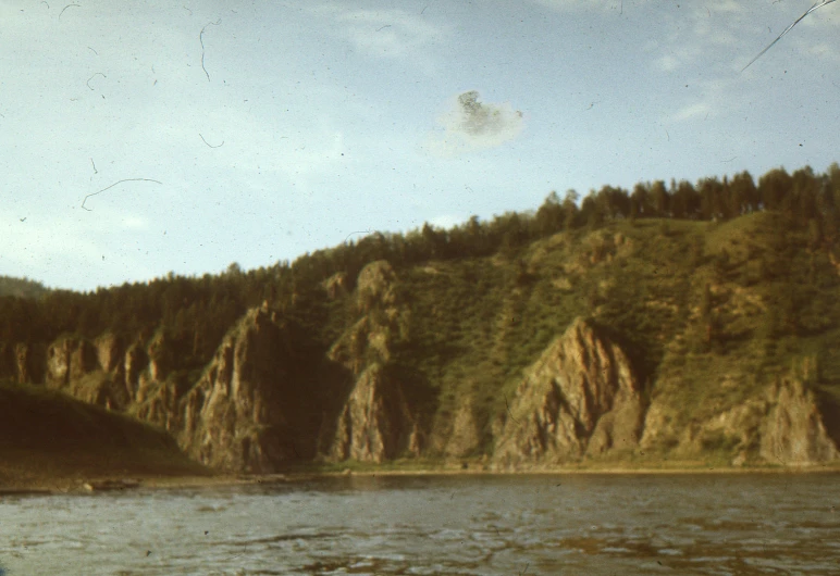 the water is choppy and the green hills appear to be steep