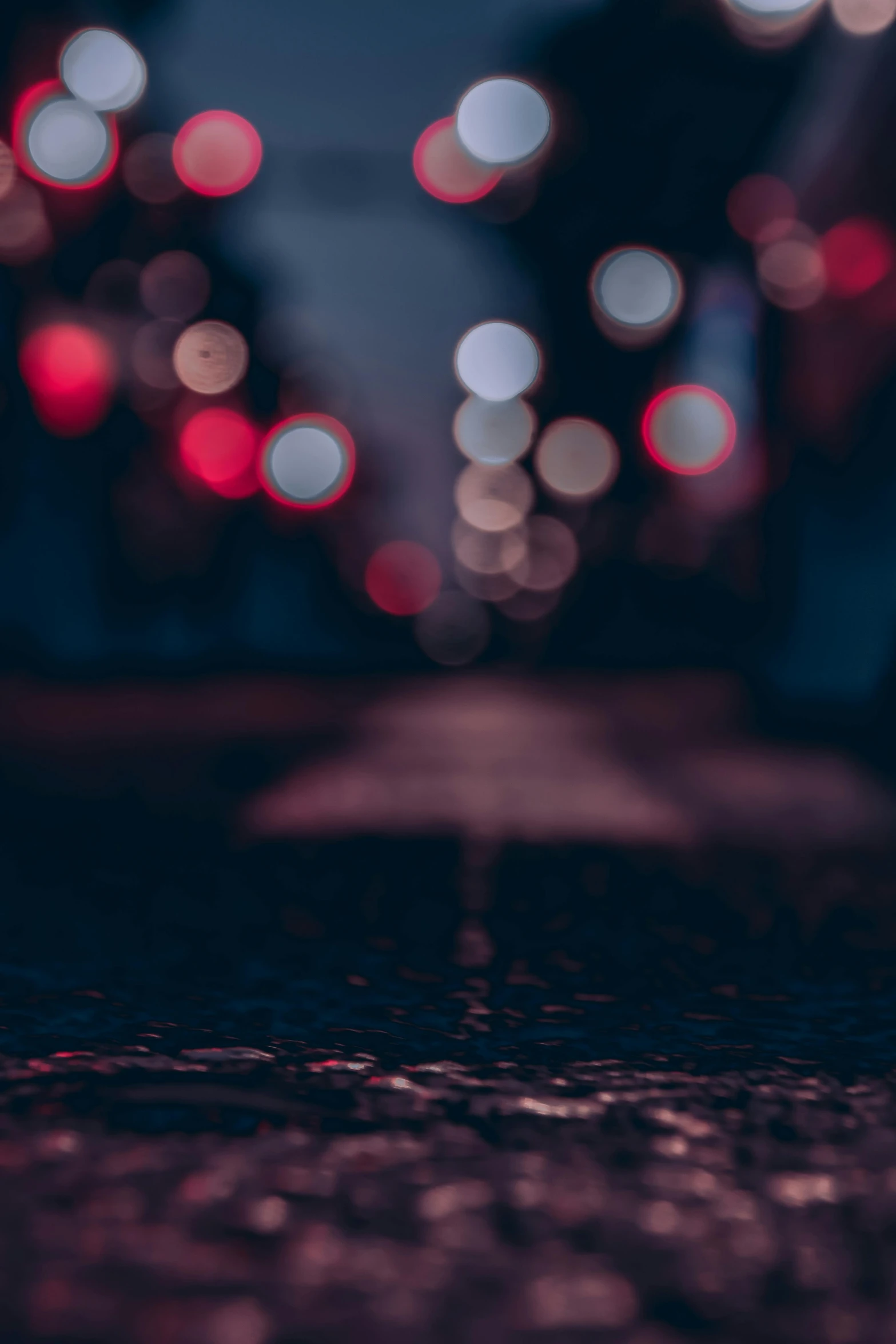 red and white lights glow as they streak across the road