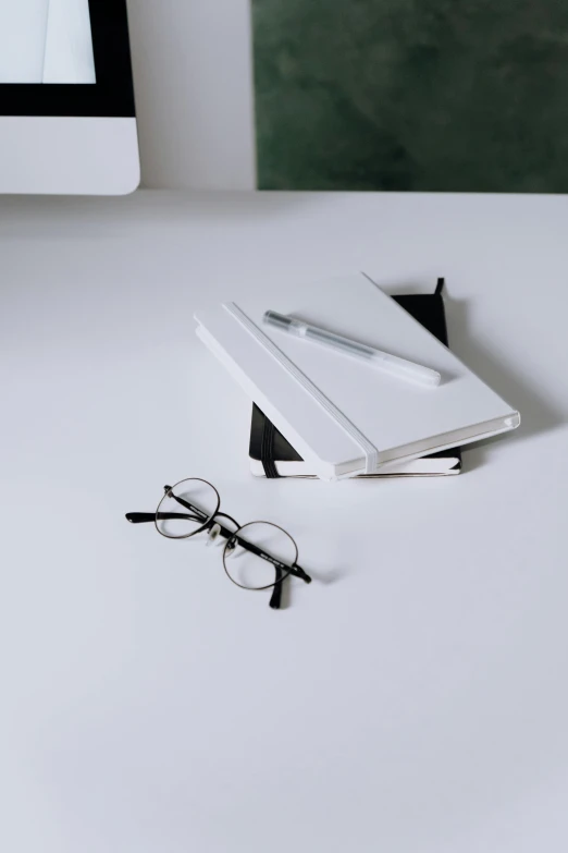 a pair of glasses are sitting next to an open book