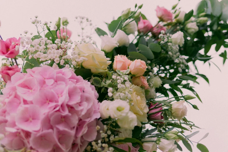 the flowers on the table are purple, pink and white