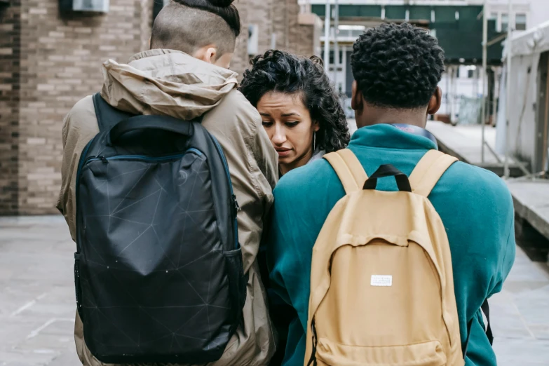 two people standing near each other with backpacks