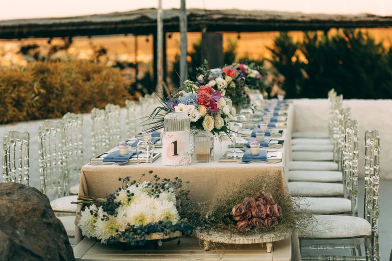 this is a dining table with blue chairs and a tablecloth