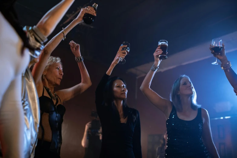 women holding up champagne flutes at a party