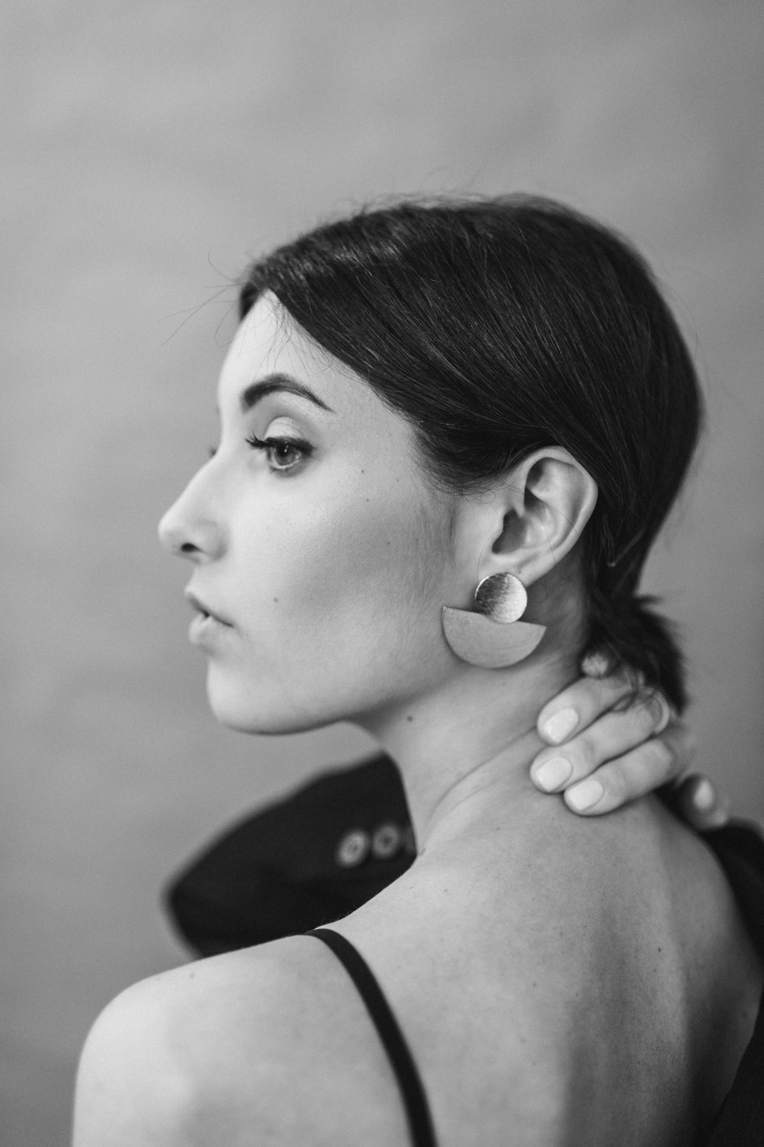 a woman wearing large earrings with a short dress