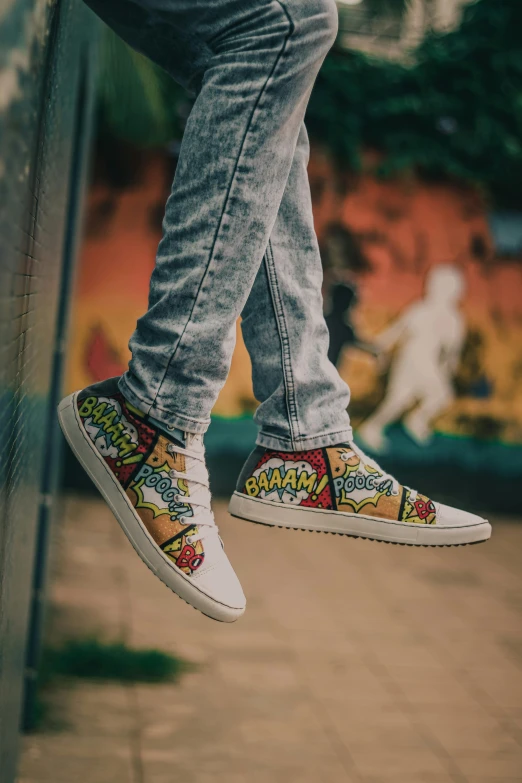 a man standing on the ledge of a building wearing his shoes