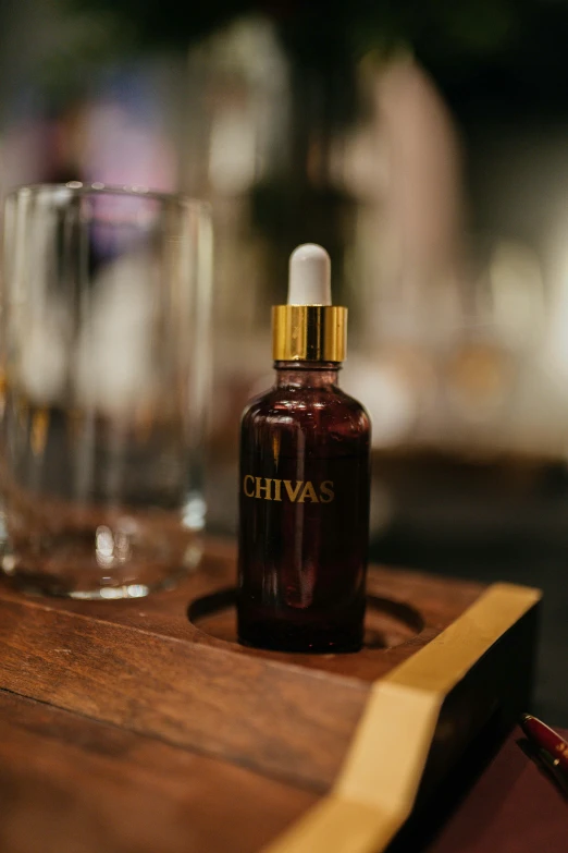 a close up of a bottle of alcohol on a wooden tray