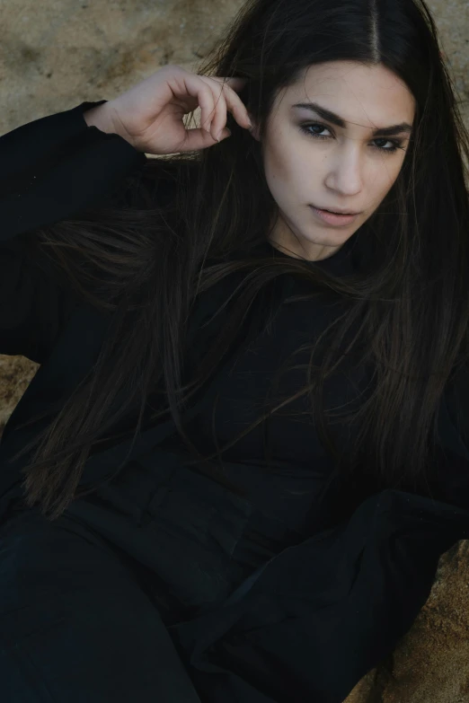 a woman wearing black is sitting down