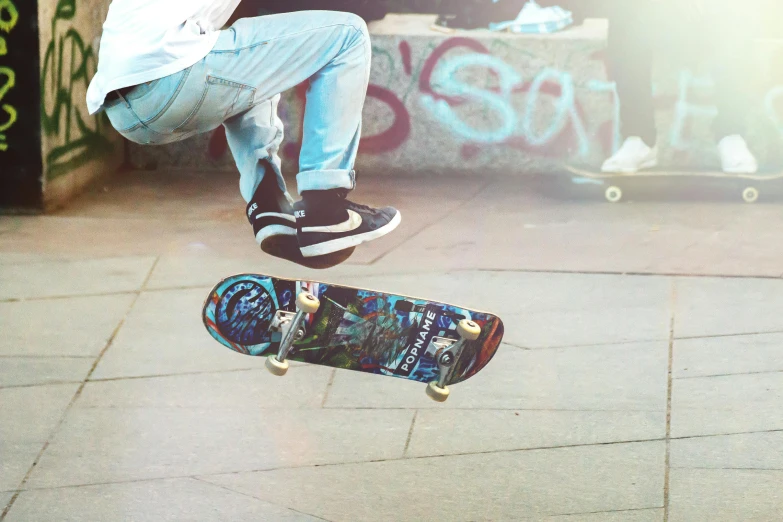 a person jumping on a skate board with their feet in the air