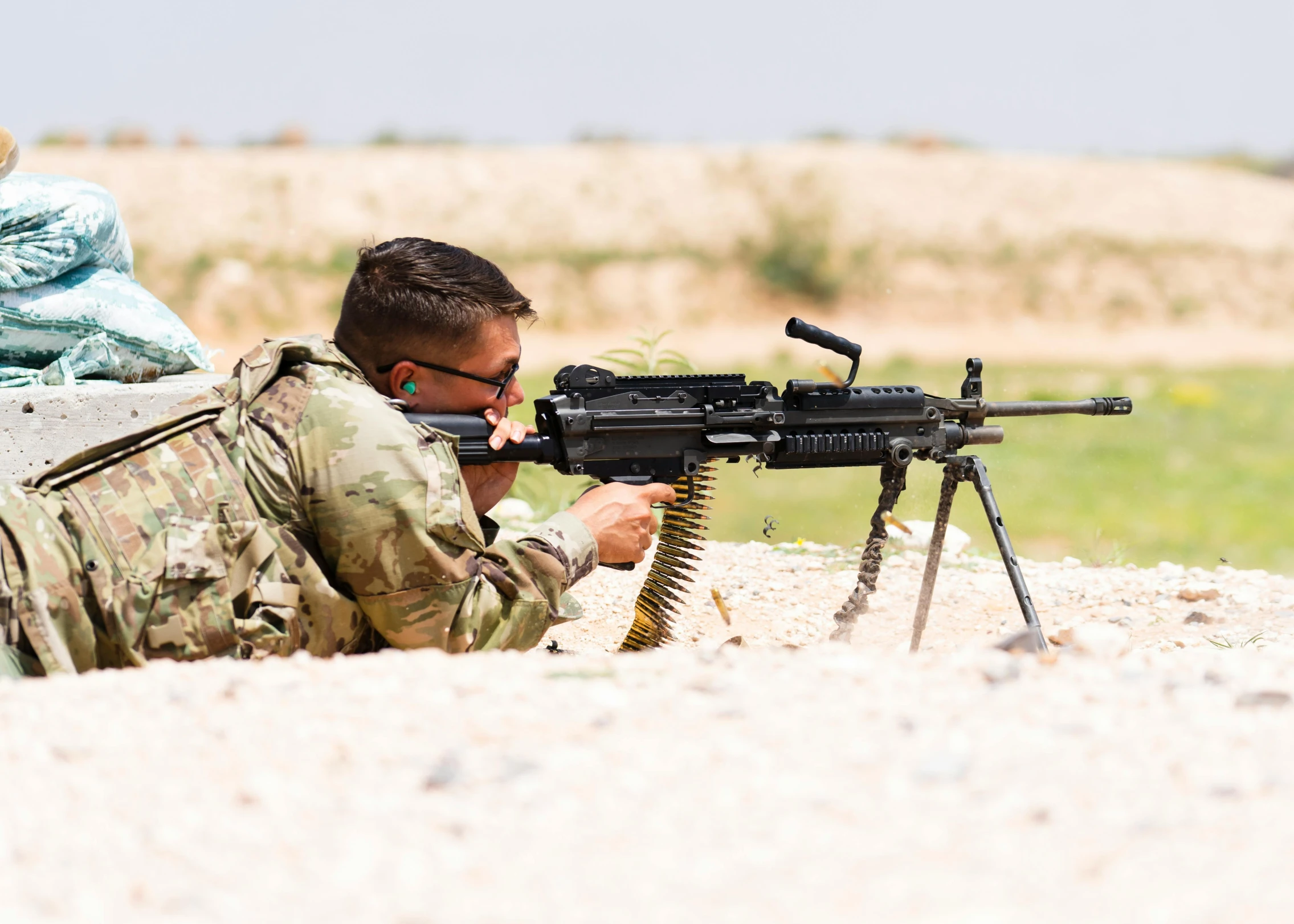 a man is aiming a gun at soing