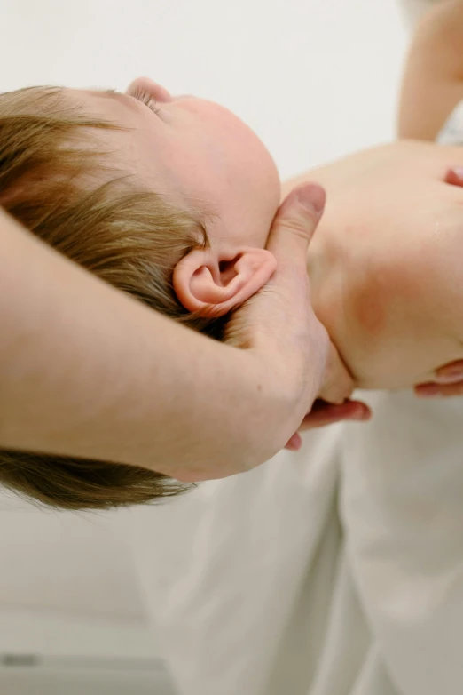 a woman placing her face into a small baby