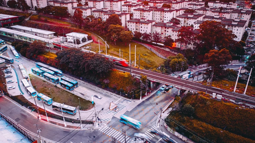 aerial view of a busy city with many buses on one street