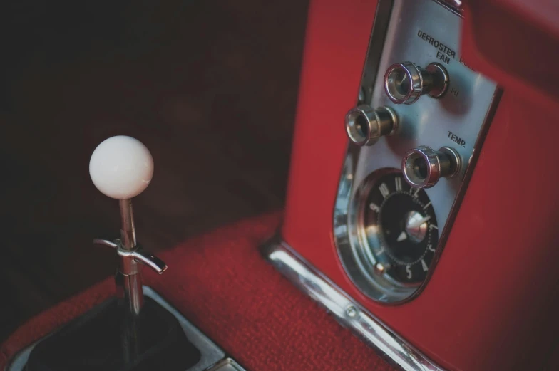 an electric  and white  sitting on top of a red seat