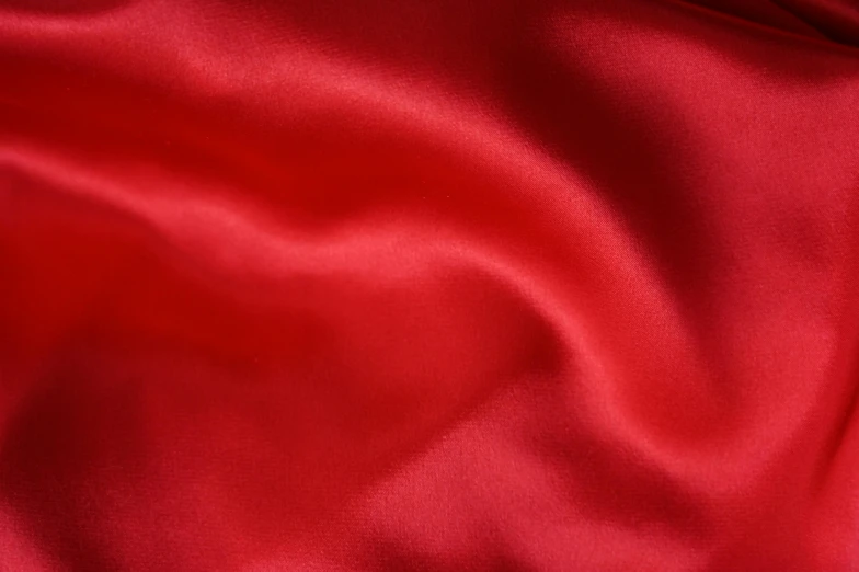 the bright red fabric has many small folds