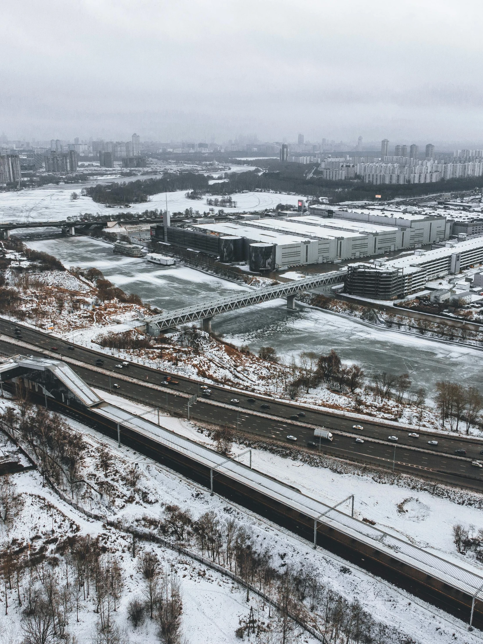 the view of a train yard with snow on it