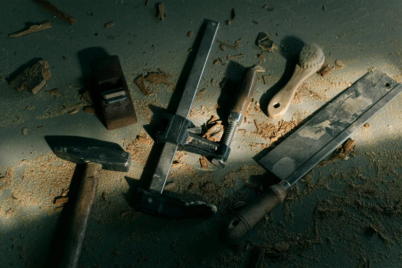 a close up of hammers and a wrench on a ground