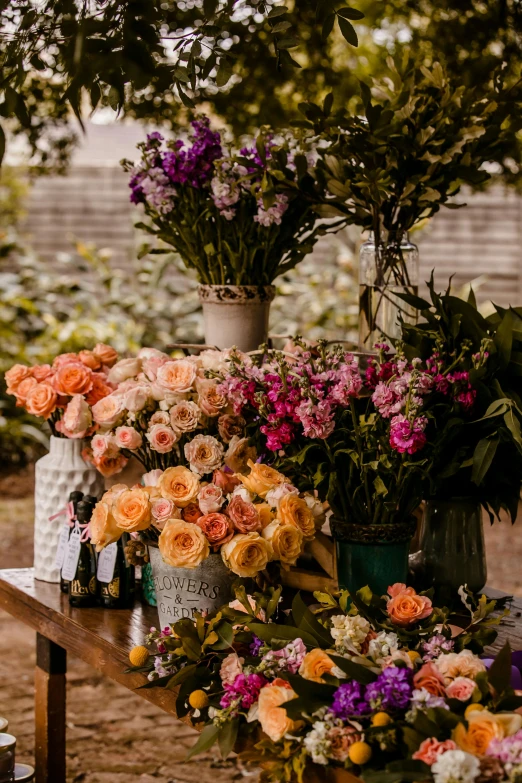 colorful flowers and bottles are on a table