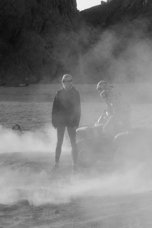 a man and woman on a water ski in front of some rocks