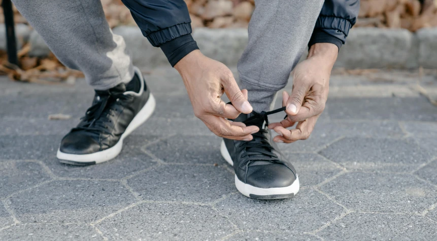 a person with their foot wrapped around another persons shoes