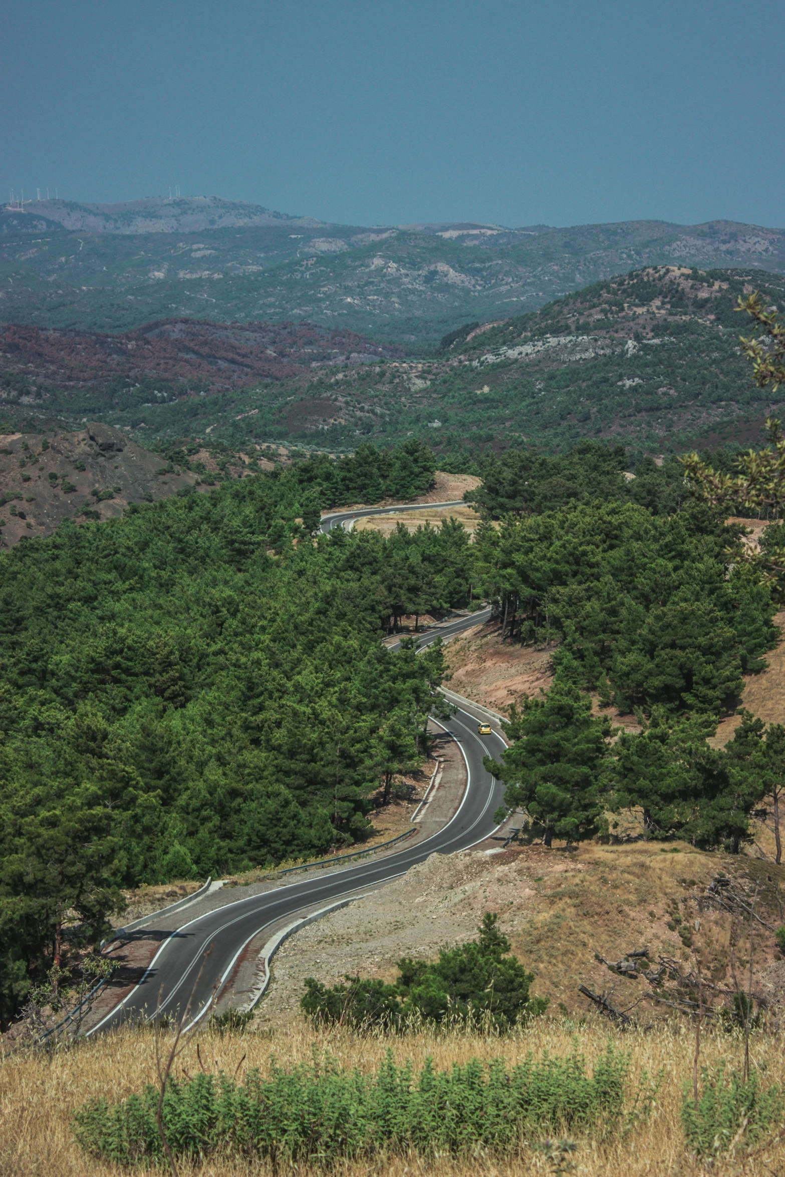 a wide winding road on top of a hill