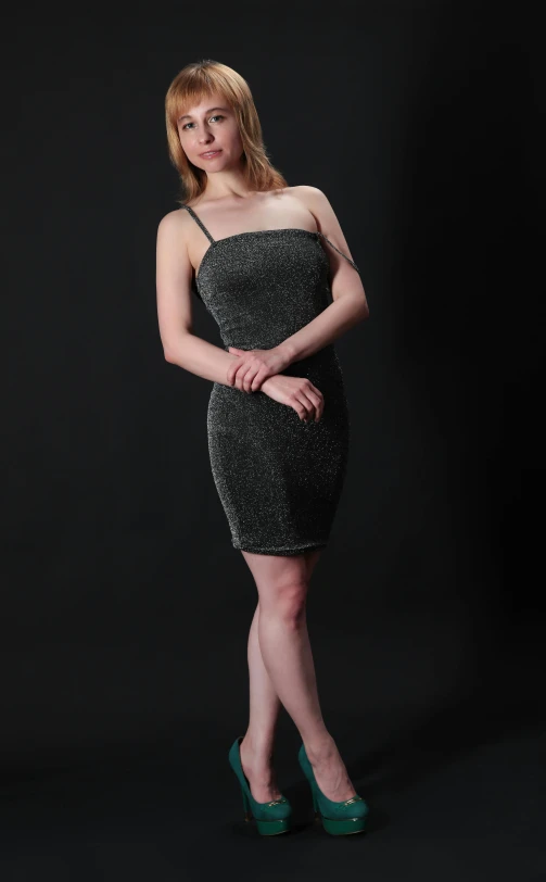 a girl in a short black dress poses for the camera