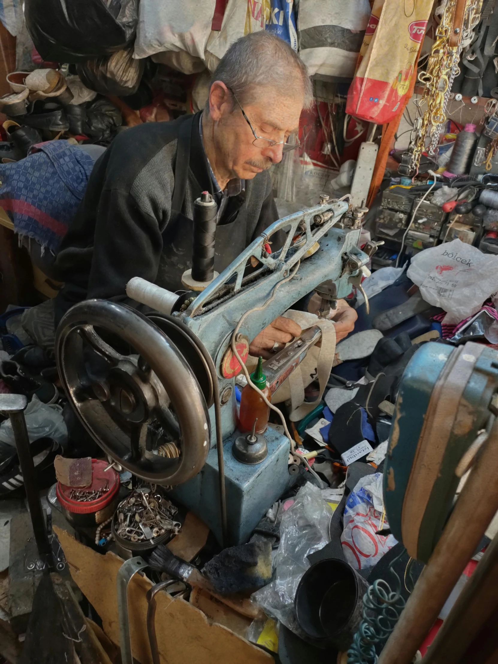 an elderly man working on a piece of machinery