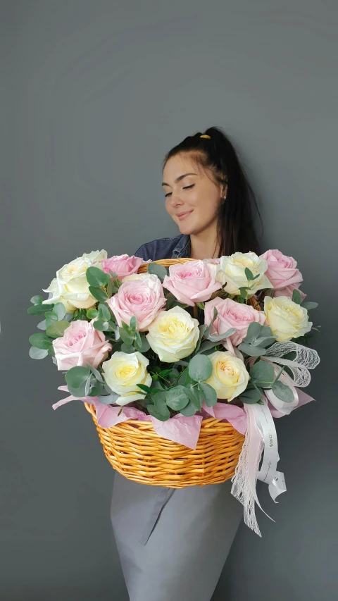 a woman holding a basket filled with roses