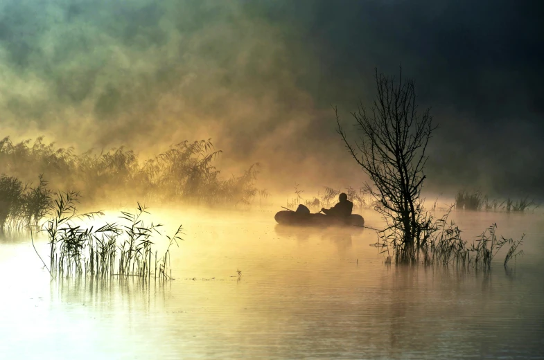 two boats on a calm river with trees in the distance