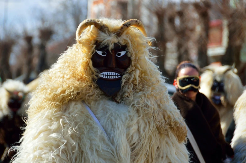 a group of people with animal heads and masks