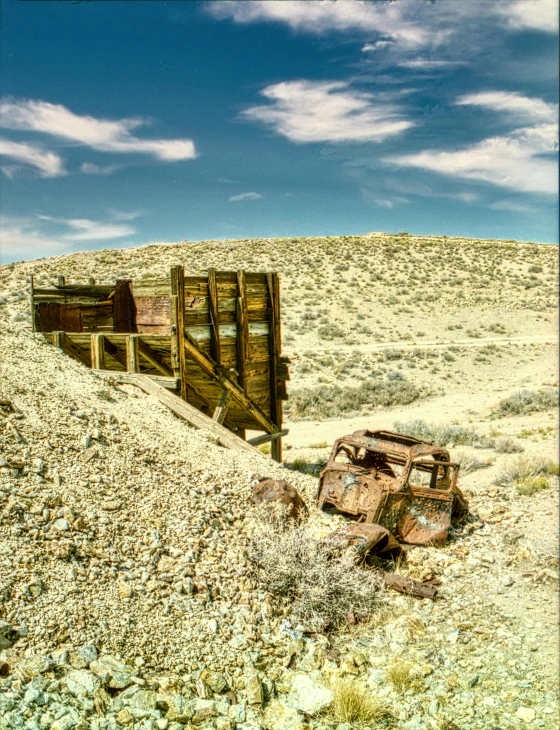 an old rusted up train sitting on the side of a mountain