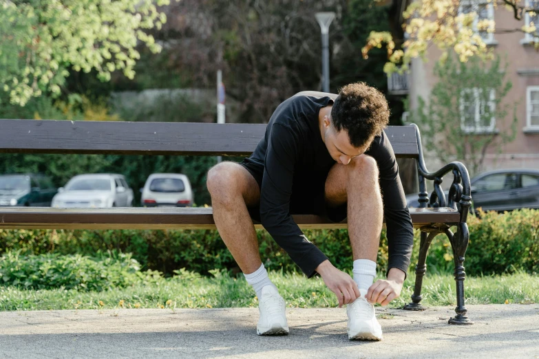 the man is sitting on the park bench