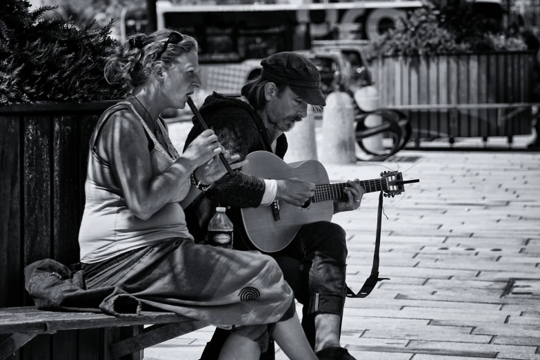 two women are playing guitar as the others look on