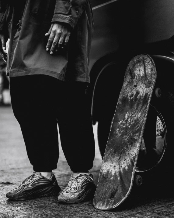 a person standing next to their snowboard with no shoes