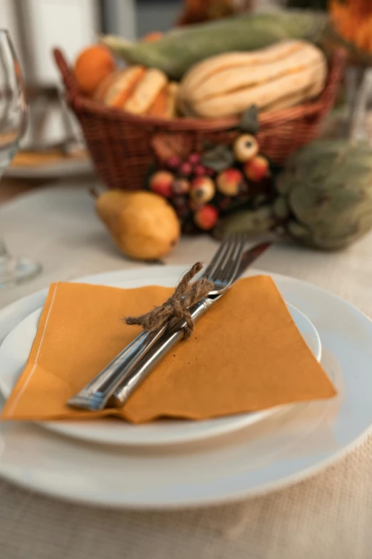 a table with place settings, napkins, and silverware