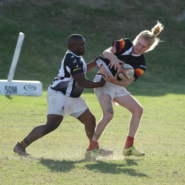 two women playing football in the grass