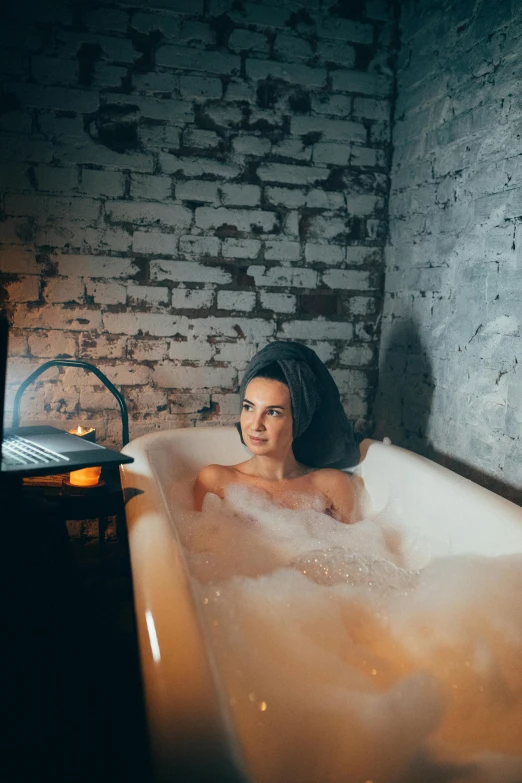 a woman taking a bath in the tub