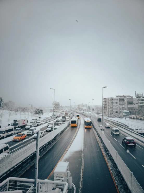 several cars on the highway in heavy winter