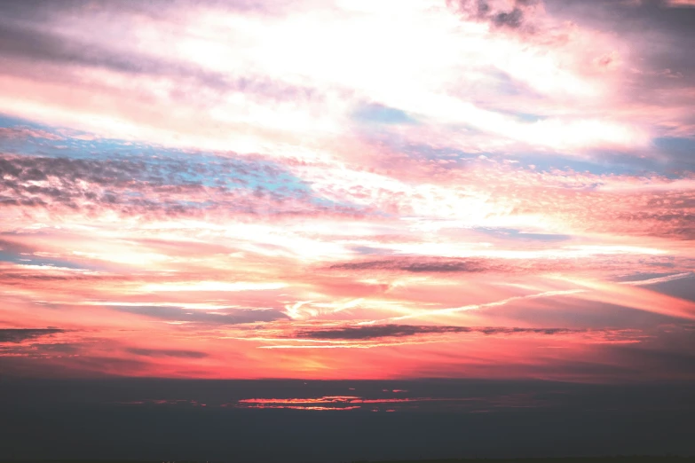 a view of the sky during sunset from a beach