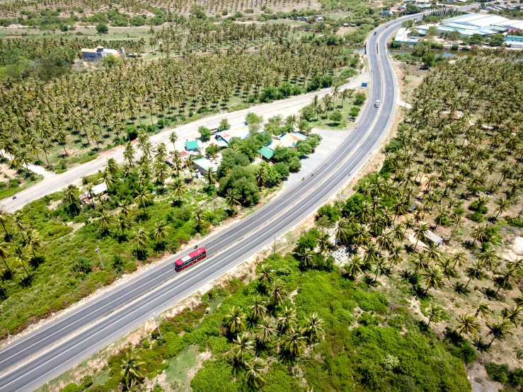 a red truck is driving down a street