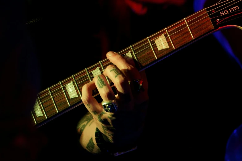 a person playing a guitar in the dark