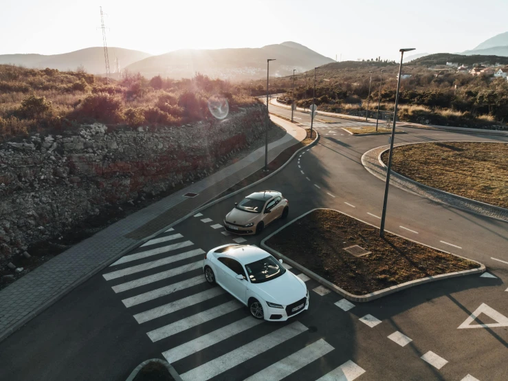 an overhead view of two cars traveling along a highway