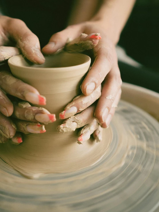 person working with pottery wheel during arts and crafts activity