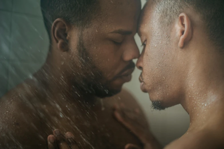 two men, one with dark hair, stare at each other