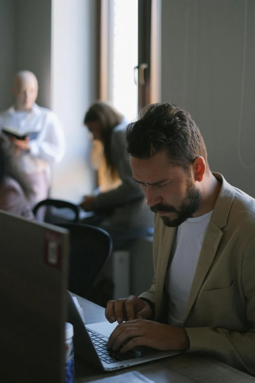 a man using a laptop computer on a desk