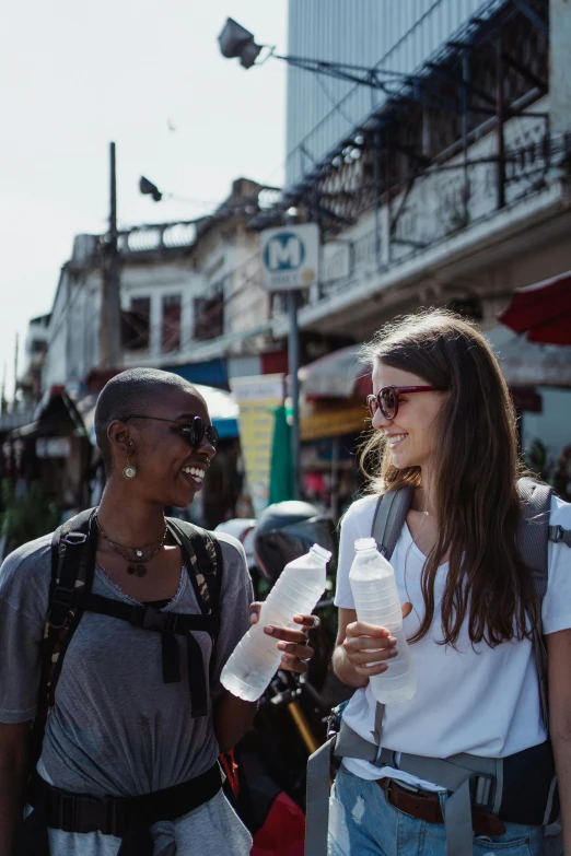 two women talk and share a meal on a street corner