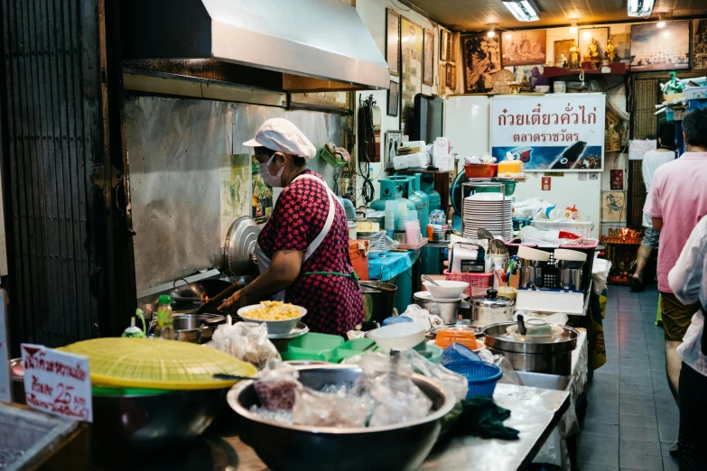 a woman is making food in the kitchen