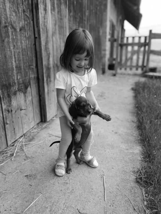 a little girl is holding a teddy bear