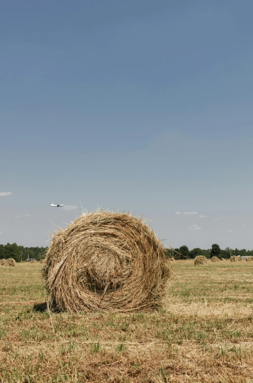 a bale of hay is lying in the middle of an open field